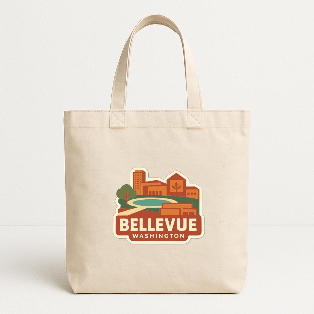 A beige tote bag with a printed design depicting a cityscape and the text "Bellevue Washington" printed on it.