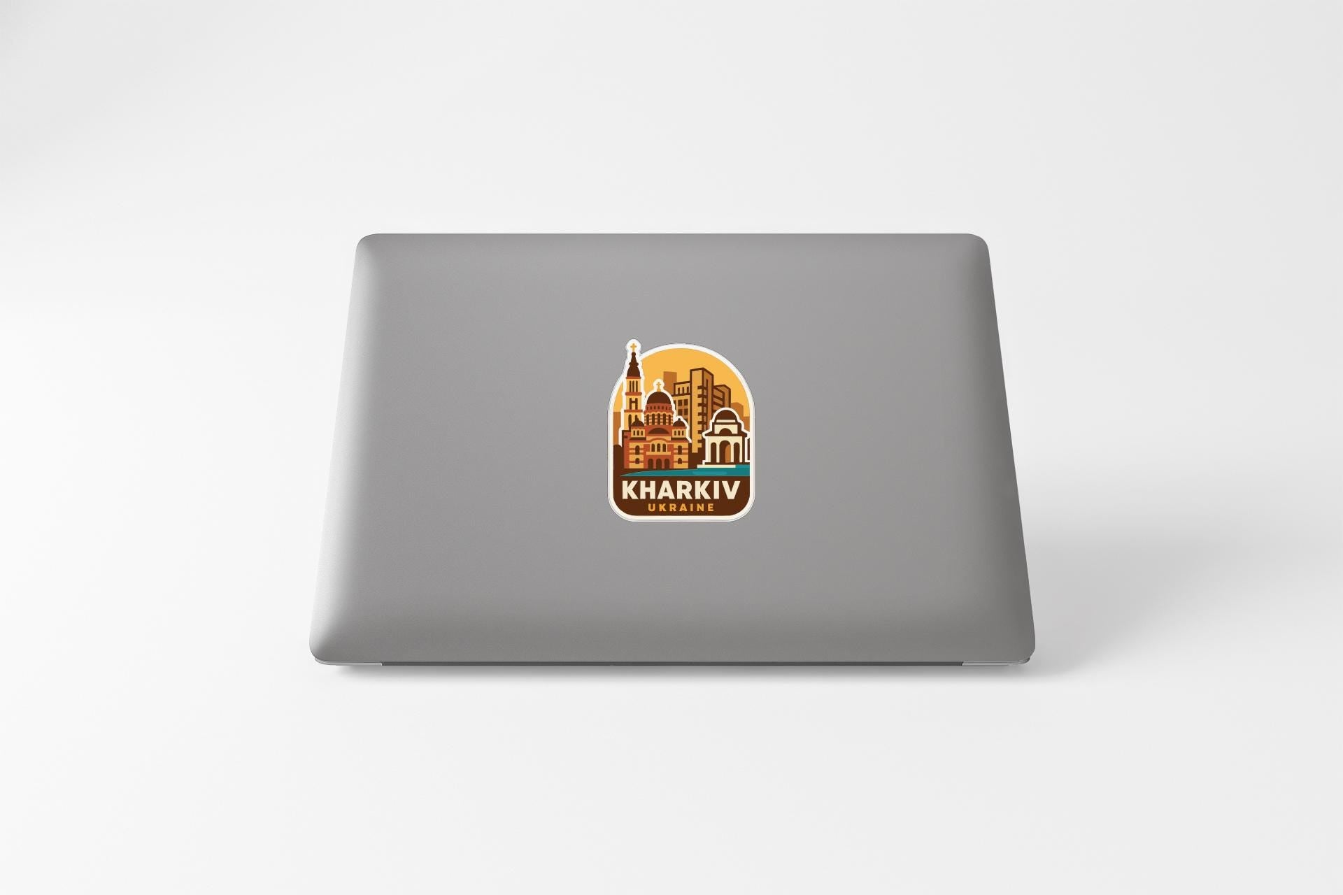 a sticker or logo of Kharkiv, the capital city of Ukraine, on the back of a laptop computer.