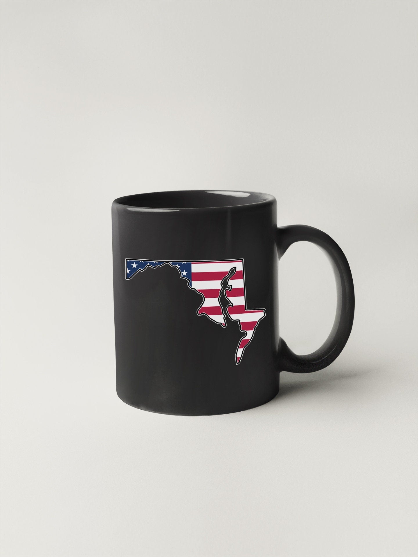 a black coffee mug with the state of florida painted on it