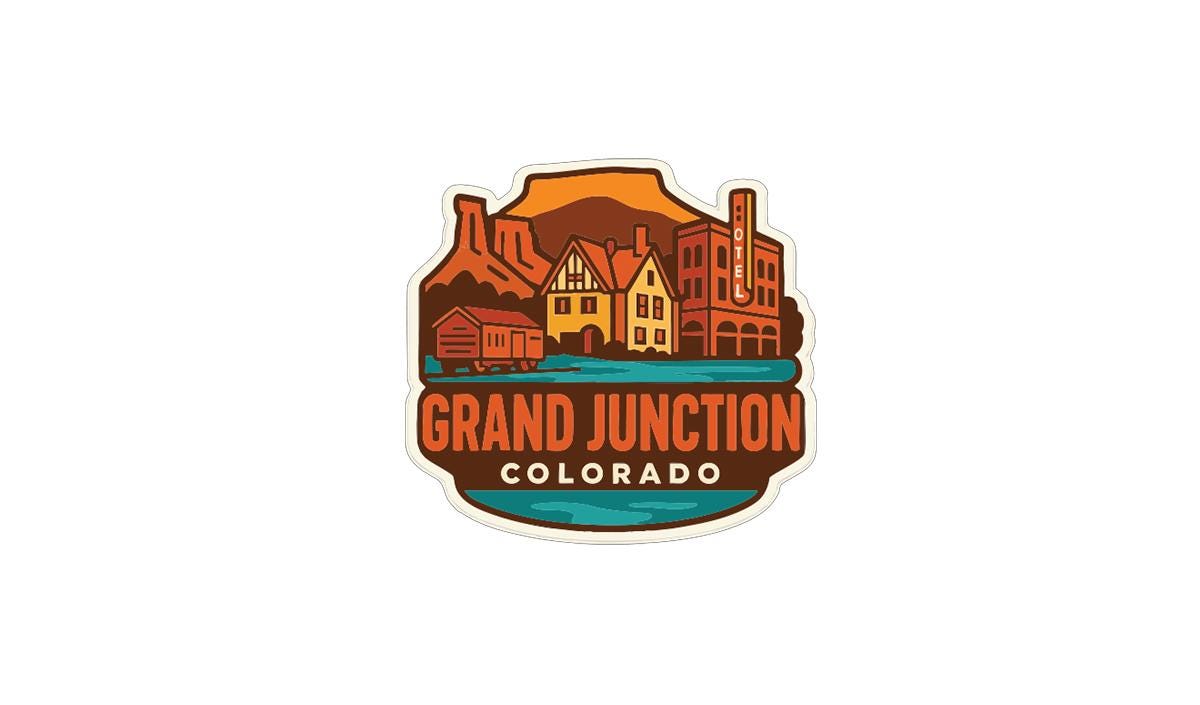 A colorful logo for the Grand Junction, Colorado, featuring a stylized illustration of the town with buildings, mountains, and a river.