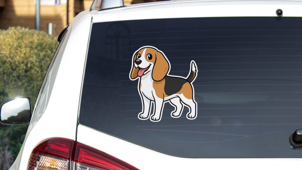 a sticker of a cartoon dog on the rear window of a car.