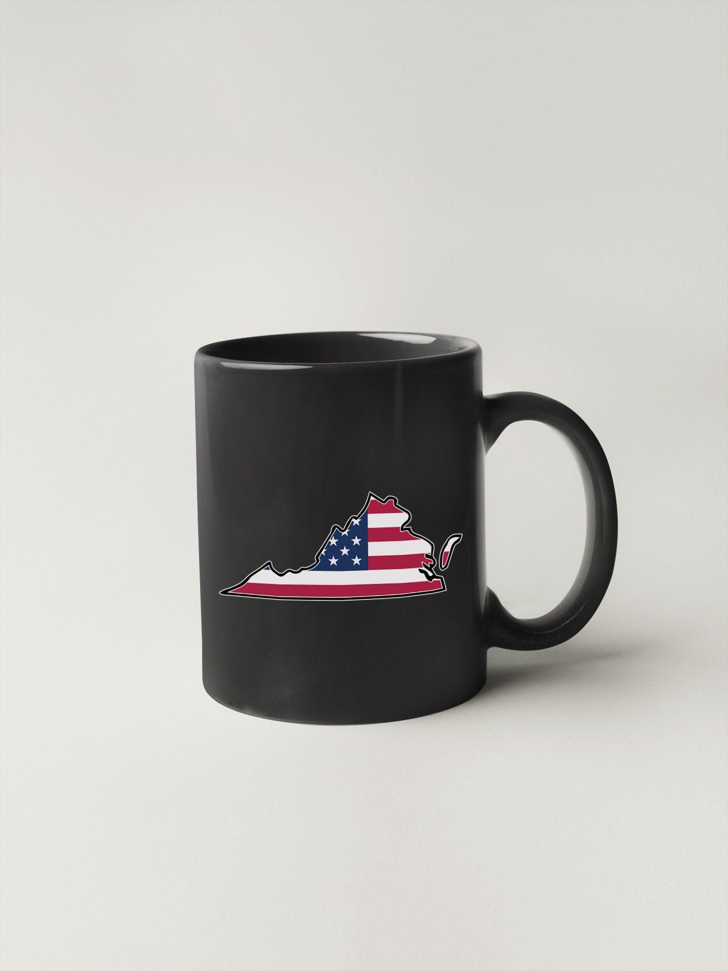 a black coffee mug with an american flag on it