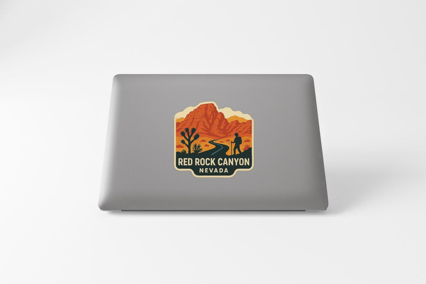 a sticker or decal of the Red Rock Canyon in Nevada on the back of a laptop computer.