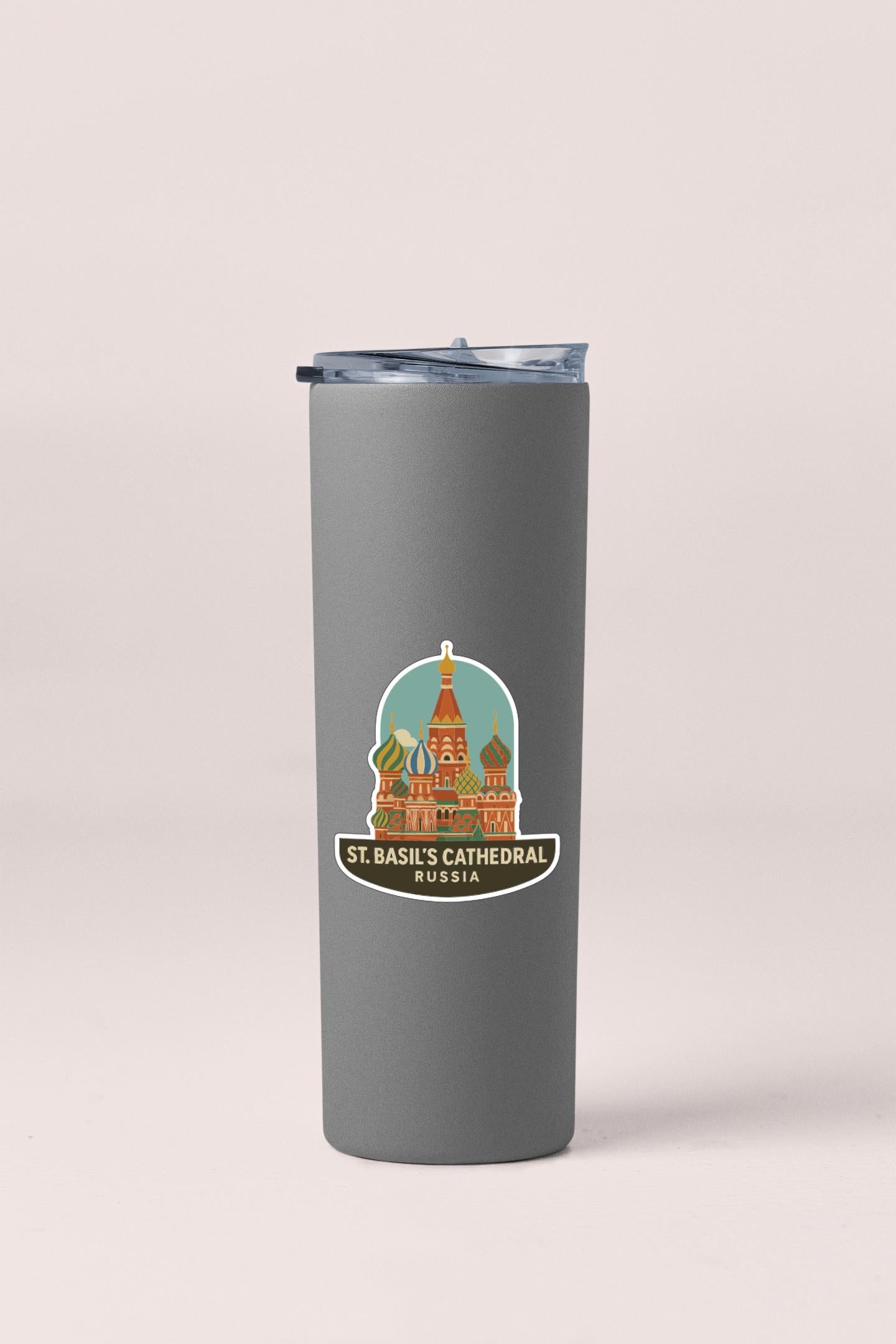 A gray insulated tumbler with a sticker depicting St. Basil's Cathedral in Moscow, Russia.