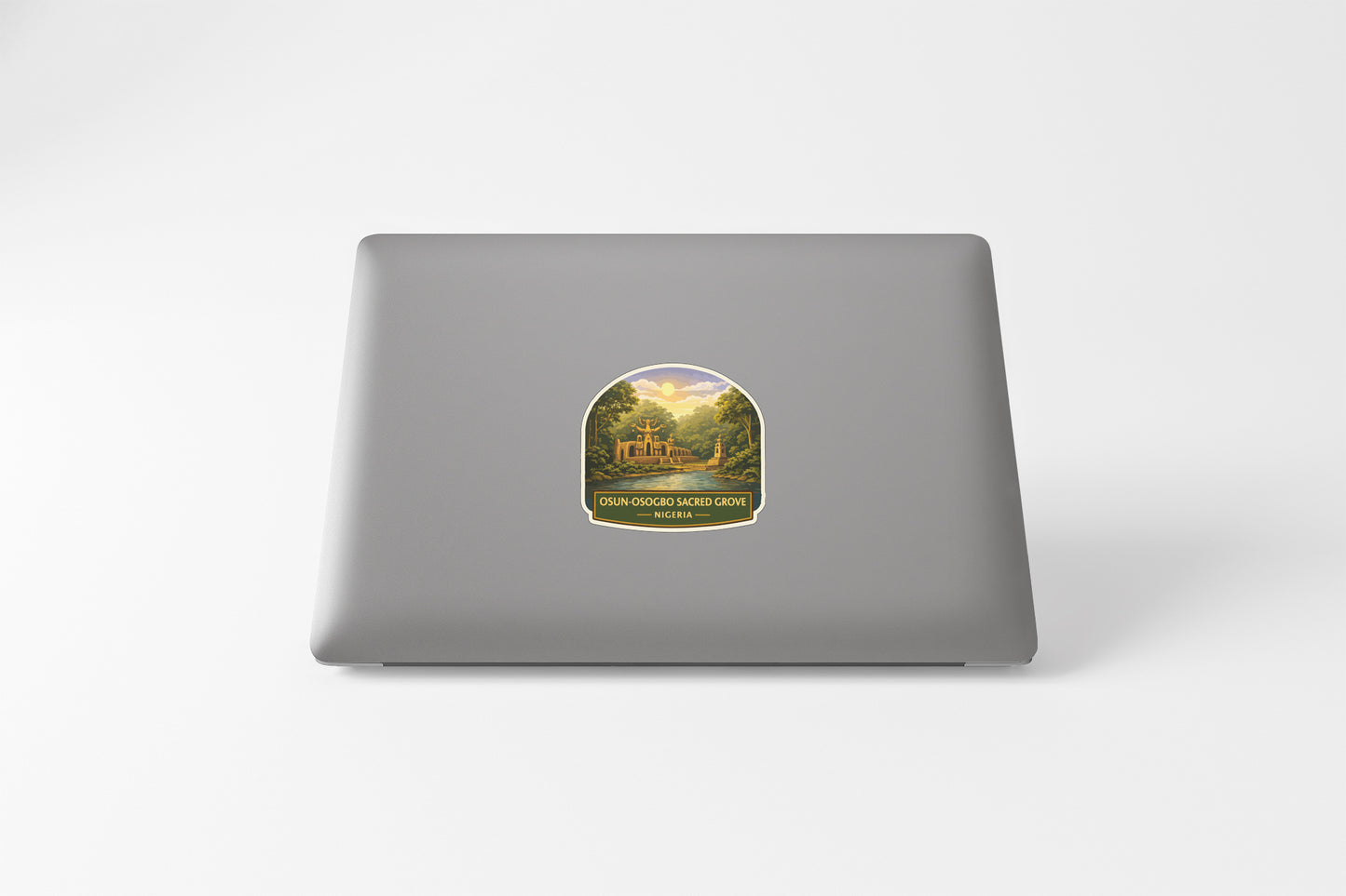 A sticker on the back of a laptop, depicting a scenic landscape with a castle or palace in the background.