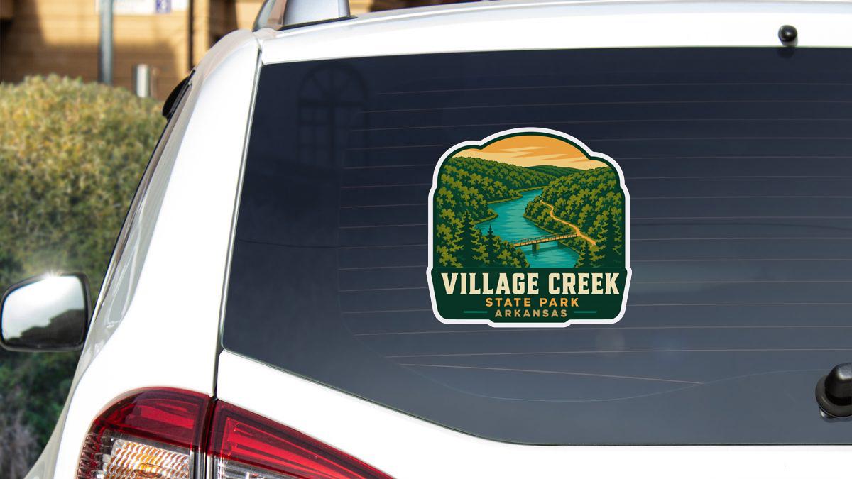 a sticker on the rear window of a white vehicle, depicting a scenic landscape with a river and forest.
