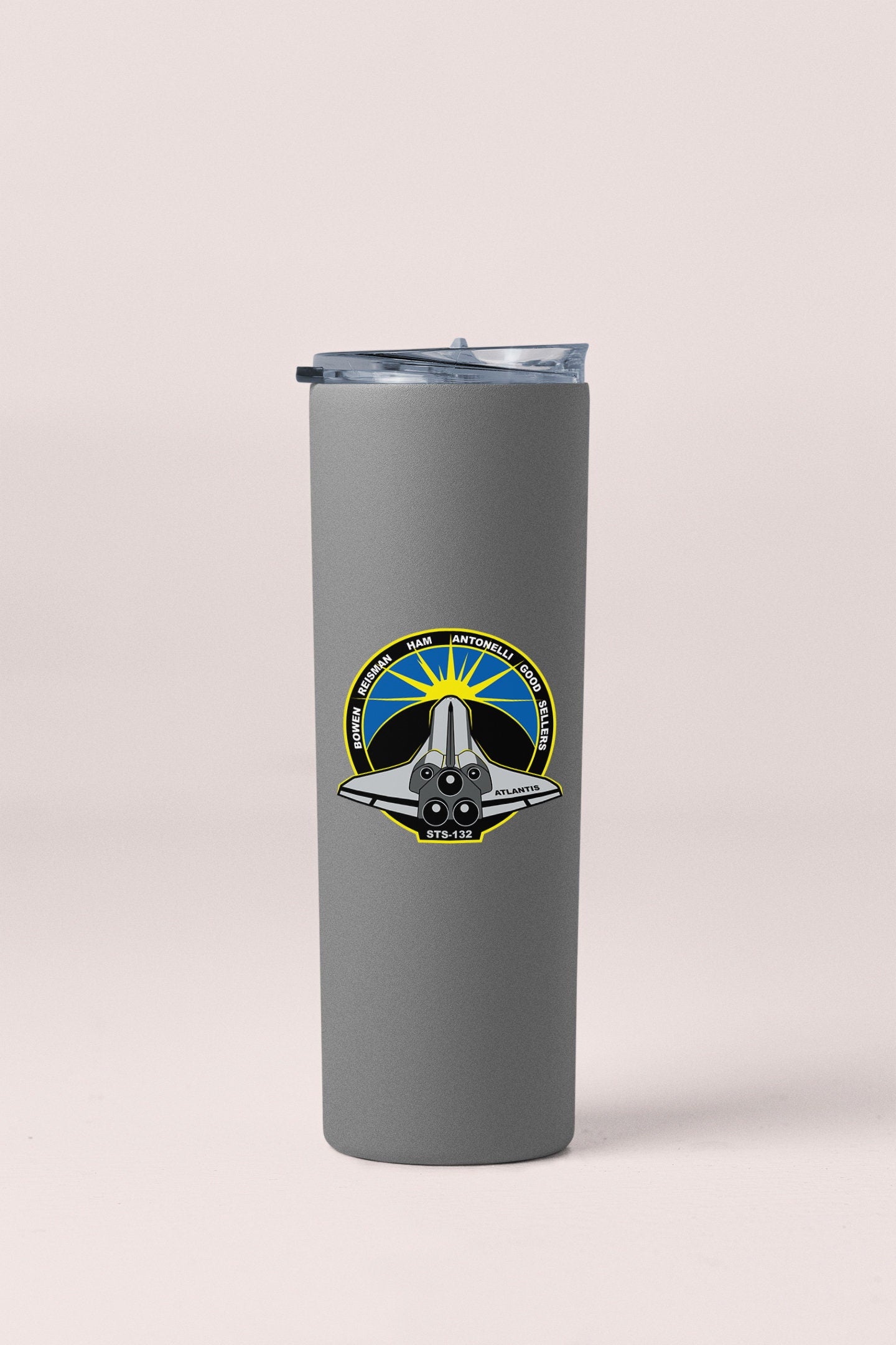 a stainless steel travel mug with a nasa emblem
