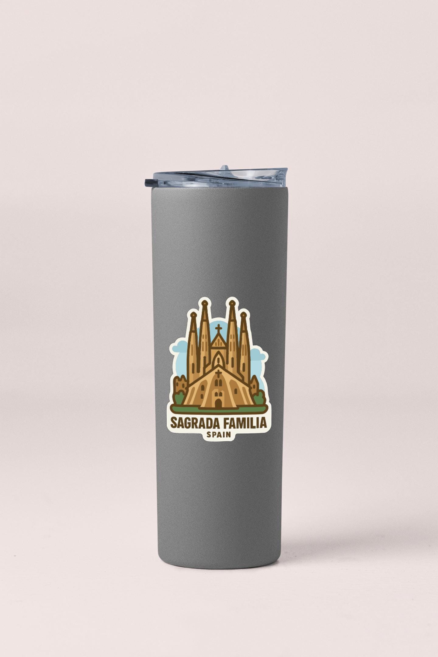 A gray tumbler with a sticker depicting the Sagrada Familia, a famous Roman Catholic church in Barcelona, Spain.