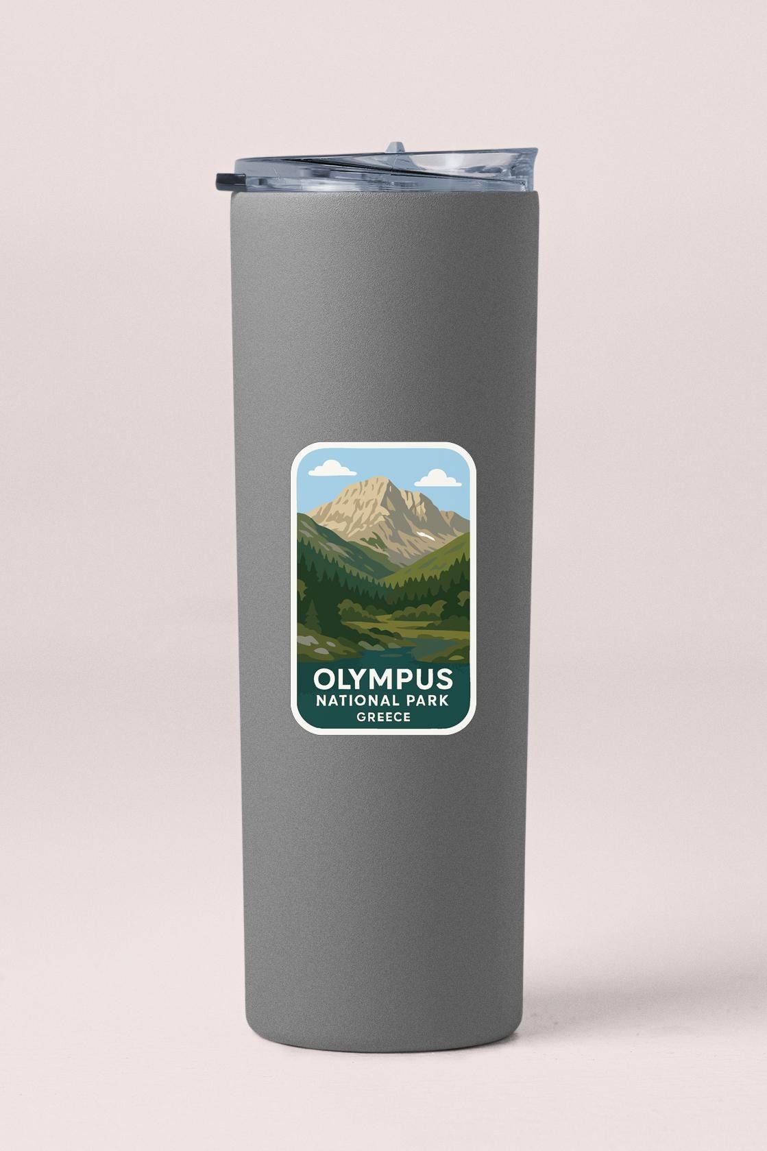A gray insulated tumbler with a label that features an illustration of a mountain landscape and the text "OLYMPUS NATIONAL PARK SCOTIA".