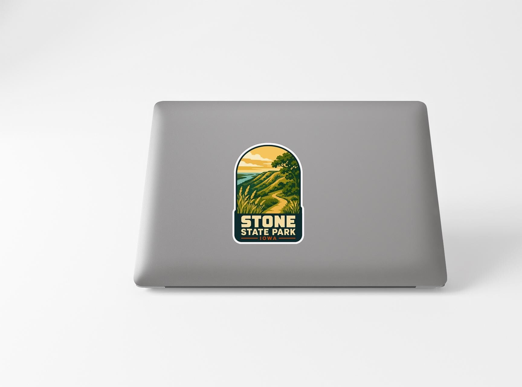 a sticker with a scenic landscape of a mountain and a lake, along with the text "STONE STATE PARK".
