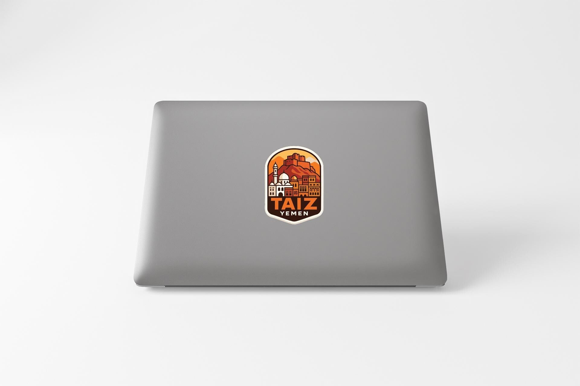 a sticker with an illustration of a cityscape on a laptop.