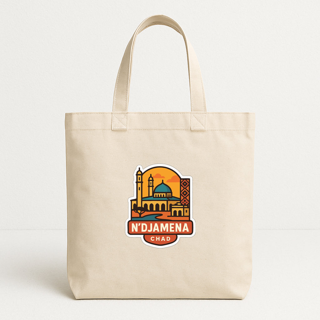 A beige tote bag with a graphic design featuring a city skyline and the text "N'DJAMENA CHAD" printed on it.