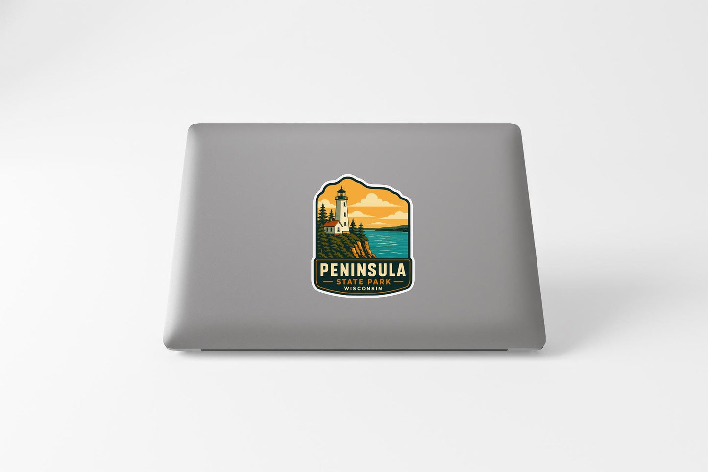 a sticker or decal of a lighthouse on the back of a laptop computer.