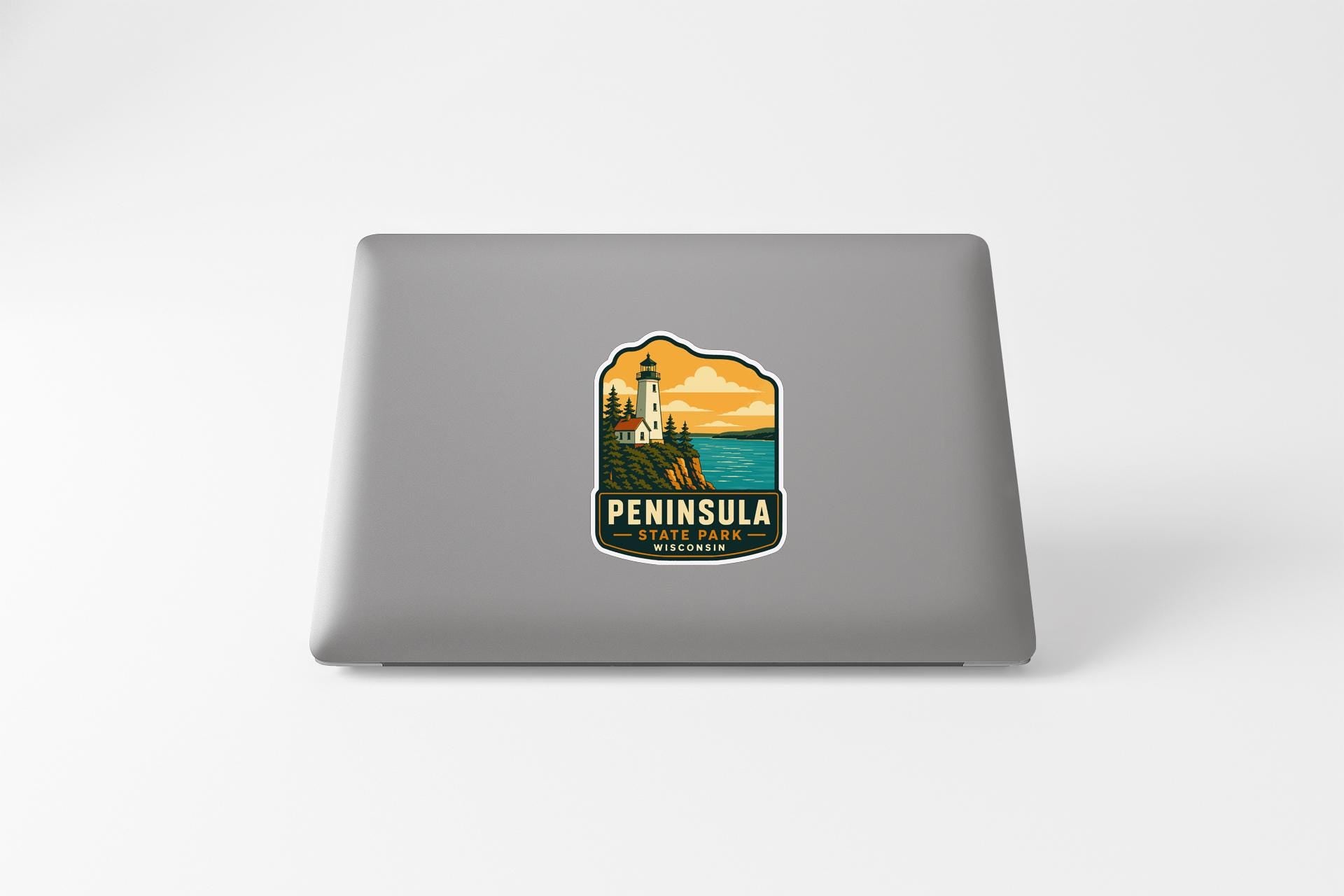 a sticker or decal of a lighthouse on the back of a laptop computer.
