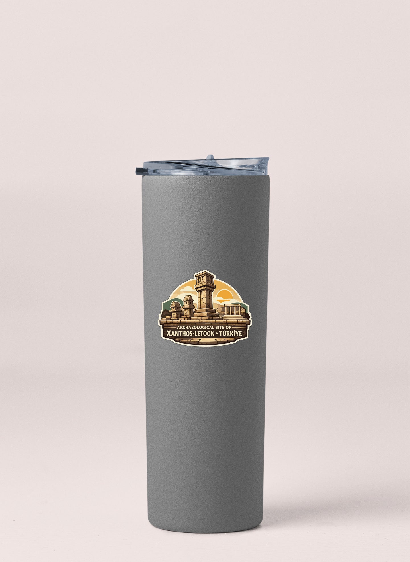 A gray cylindrical thermos with a lid and a sticker depicting a tower and a building.