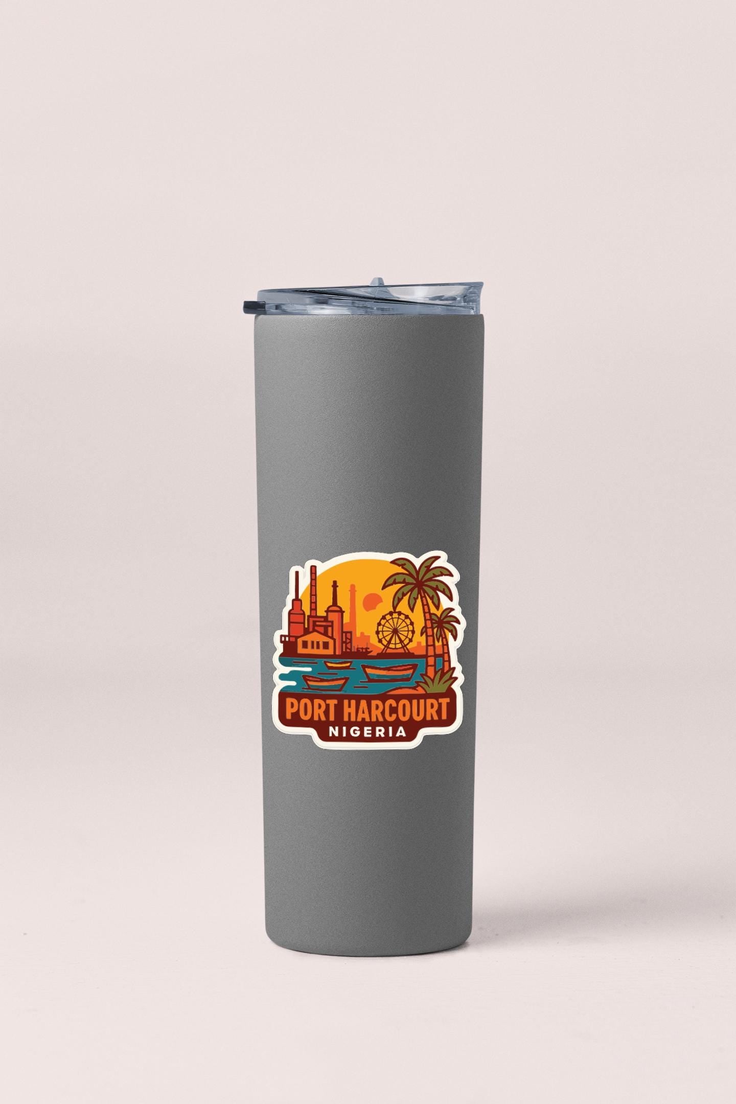 A gray insulated tumbler with a printed label that says "PORT HARCOURT NIGERIA".