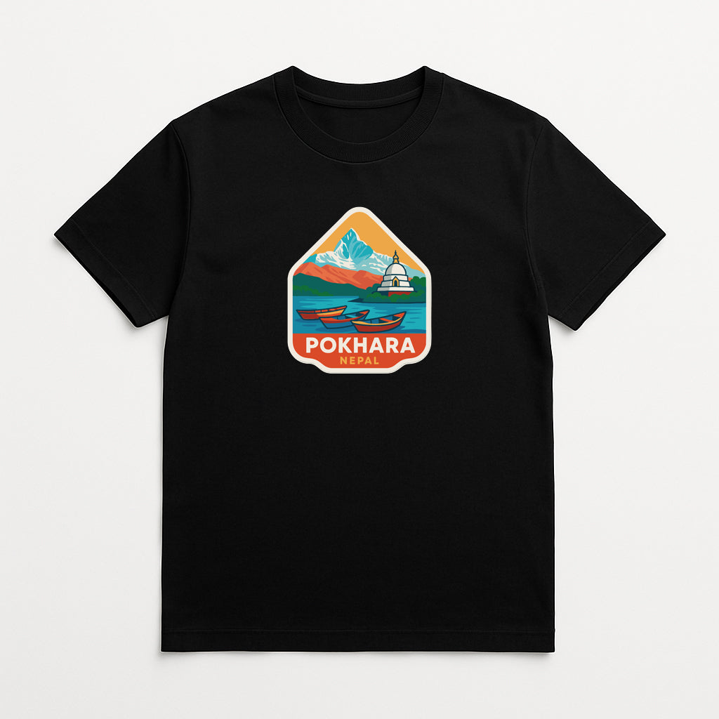 A black t-shirt with a colorful graphic design depicting a mountain landscape with a boat on a lake.