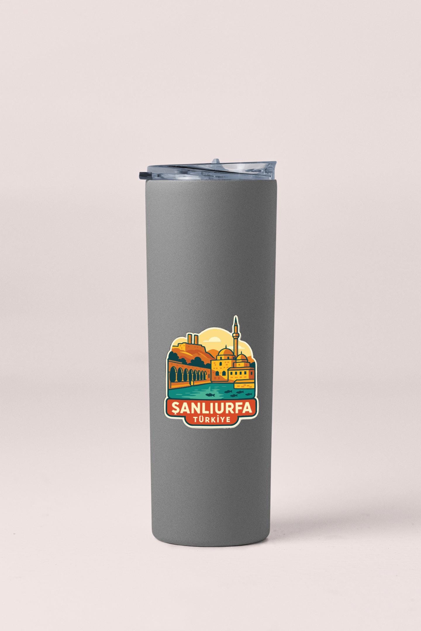 A gray insulated tumbler with a sticker depicting a cityscape and the text "SANLIURFA TURKISH".