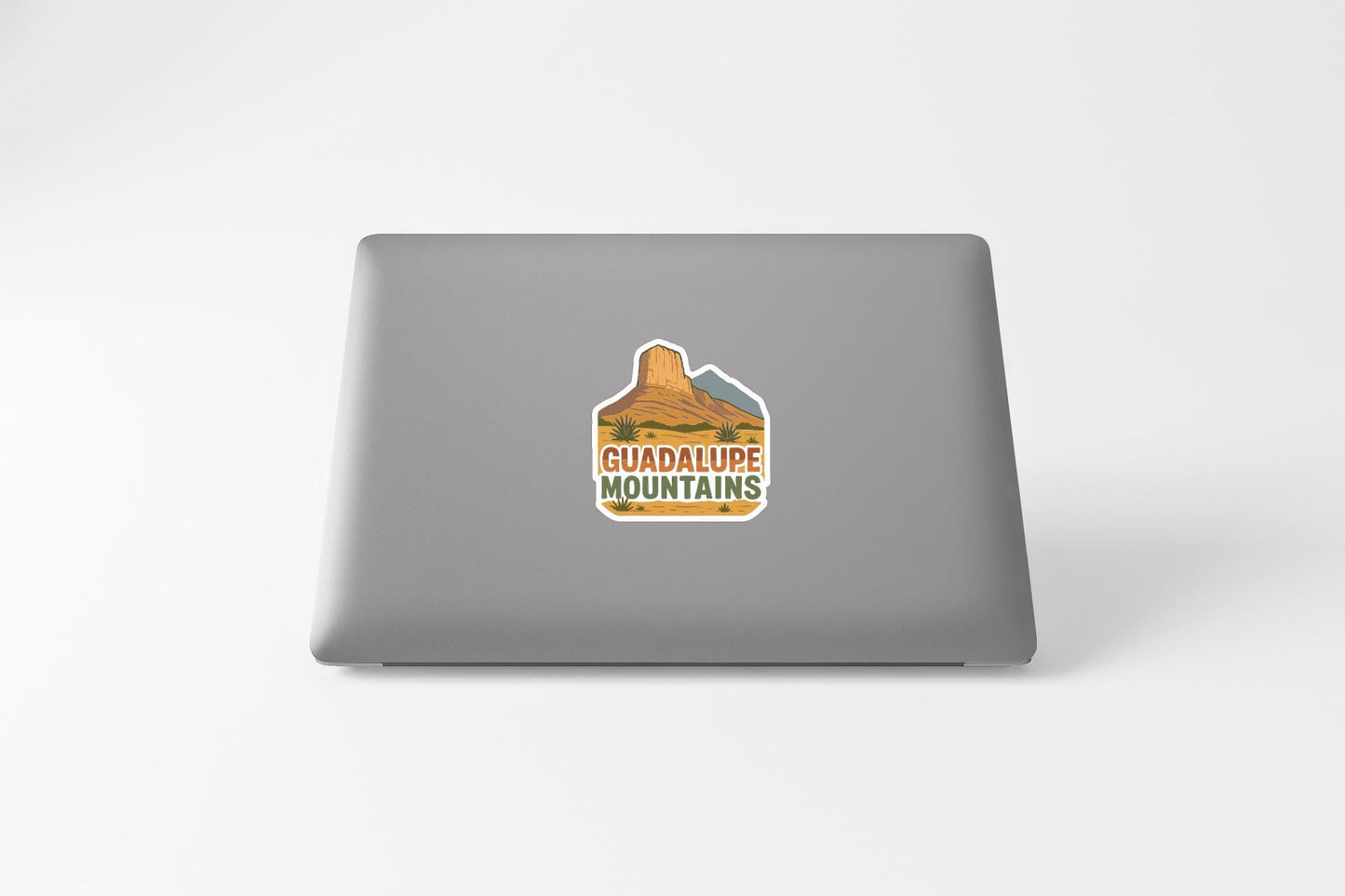 a sticker with a mountain and the text "GUADALUPE MOUNTAINS" on the back of a laptop.