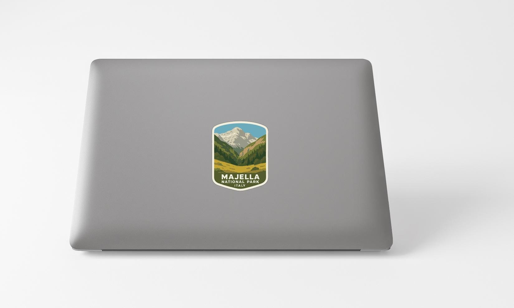 A sticker with a mountain landscape on a laptop.