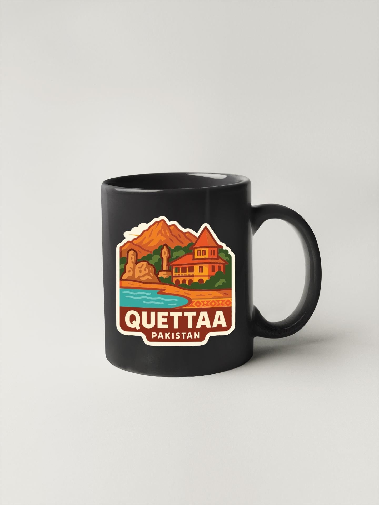 A black coffee mug with a colorful illustration of a scenic landscape and the text "QUETTAA PAKISTAN" printed on it.