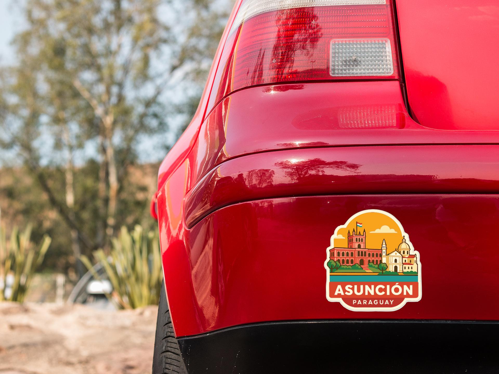 the rear end of a red car with a sticker on the trunk that says "ASUNCION PARAGUAY".