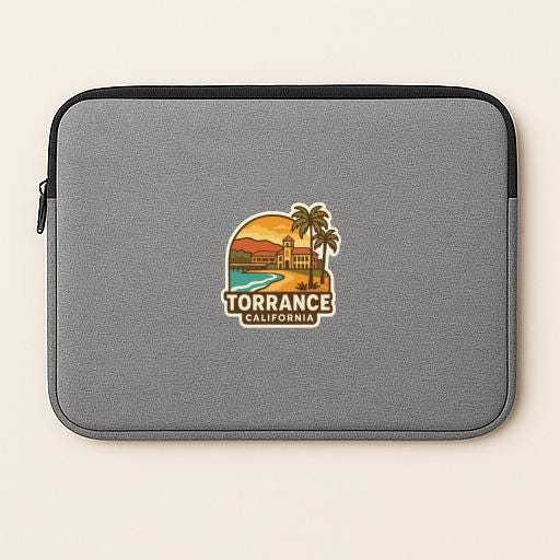 A gray laptop sleeve with a graphic design featuring a beach scene and a palm tree, along with the text "TORRANCE, CALIFORNIA".