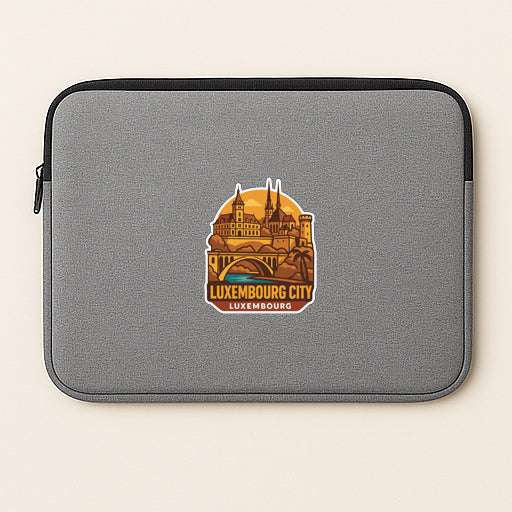 A gray laptop sleeve with a sticker depicting the city of Luxembourg.