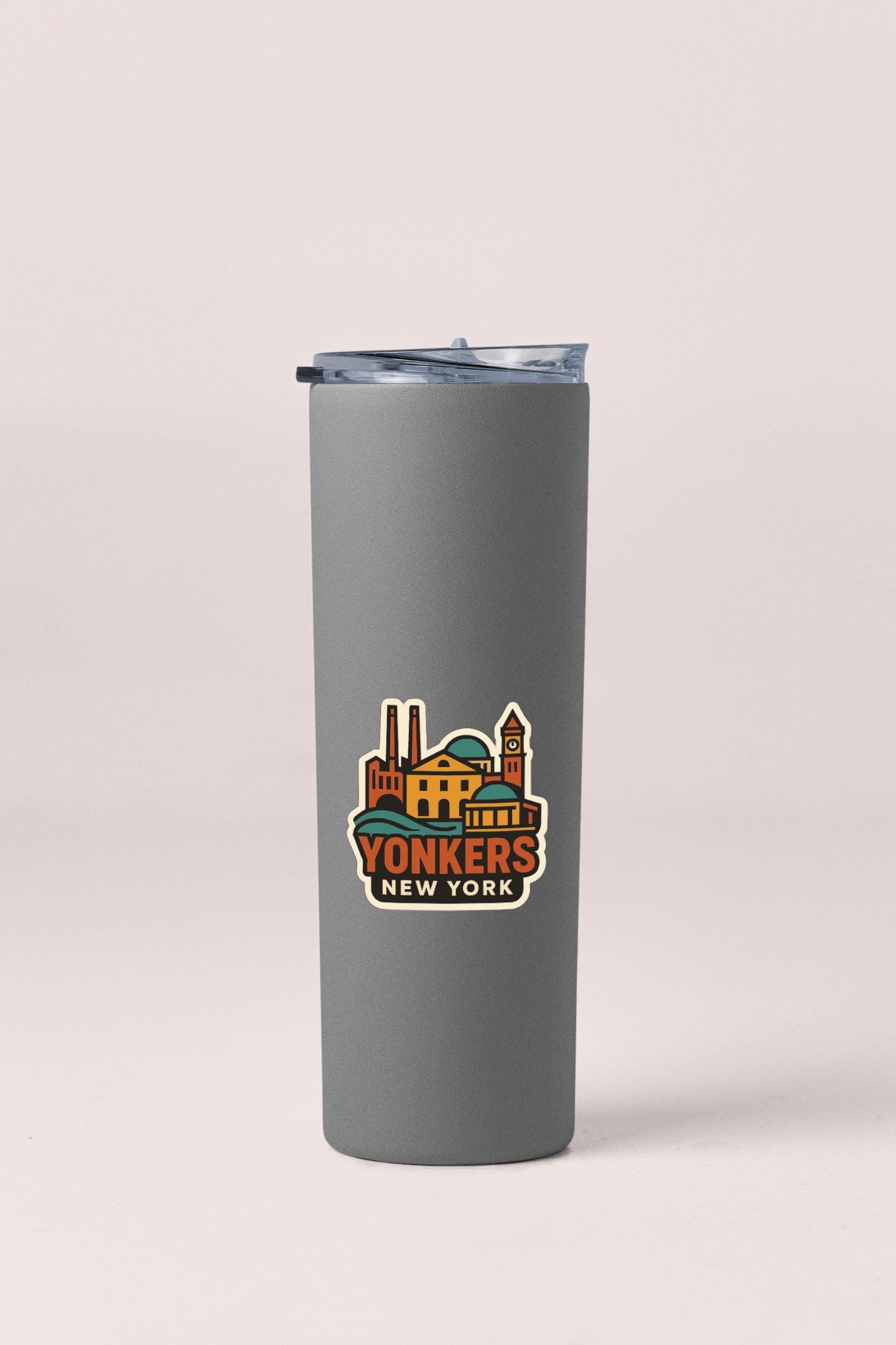 A gray insulated tumbler with a lid and a colorful graphic sticker depicting a city skyline.