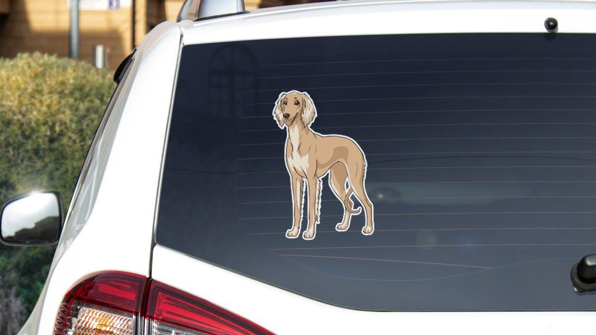 a sticker of a dog on the rear window of a car.