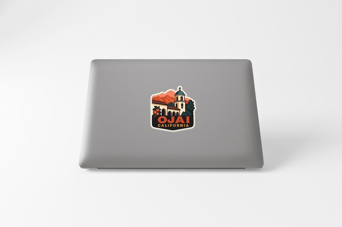 A sticker on the back of a laptop, depicting a scenic view of Ojai, California.