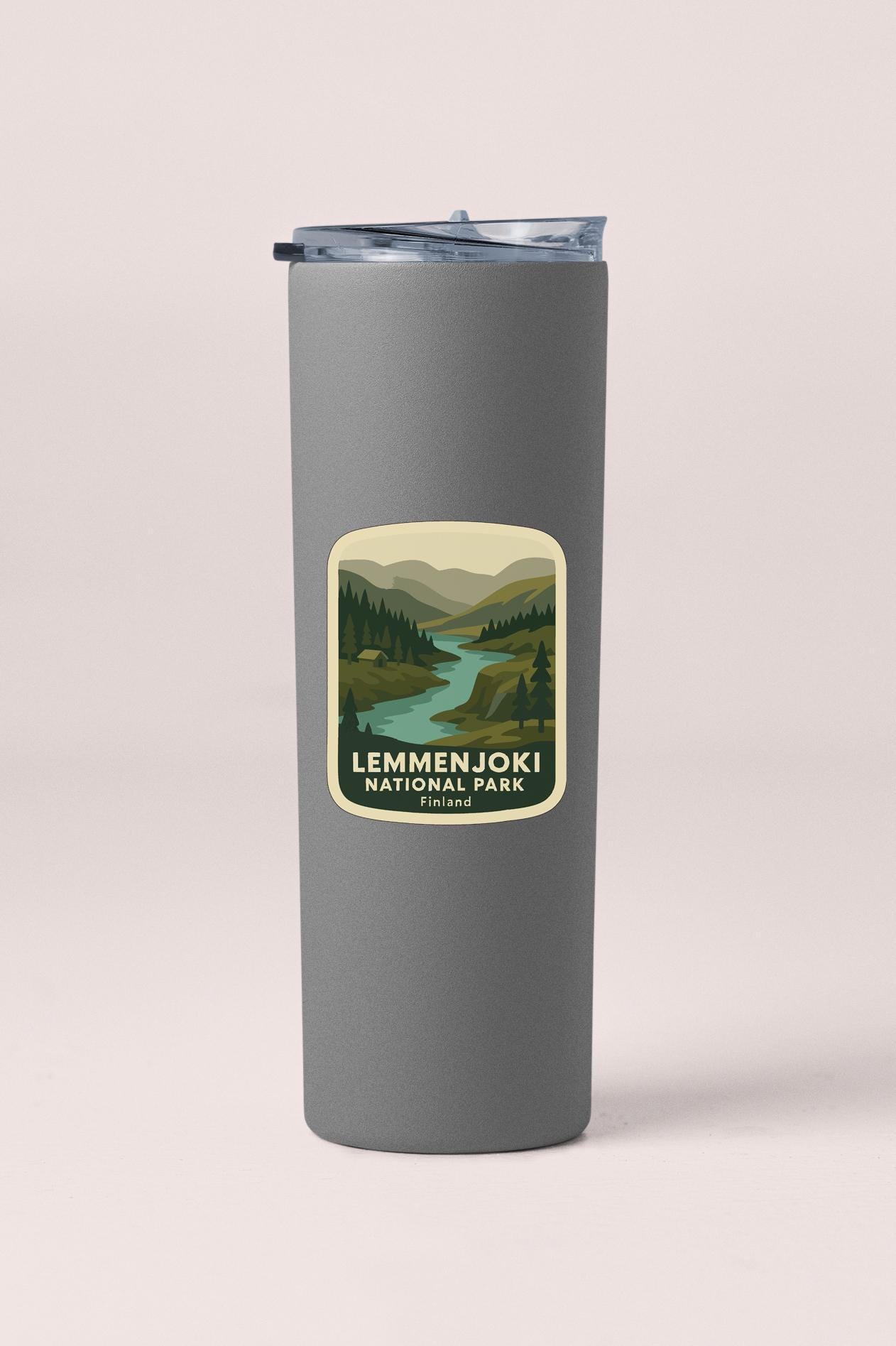A gray insulated tumbler with a label that says "LEMMENJOKI NATURAL PARK FINLAND".
