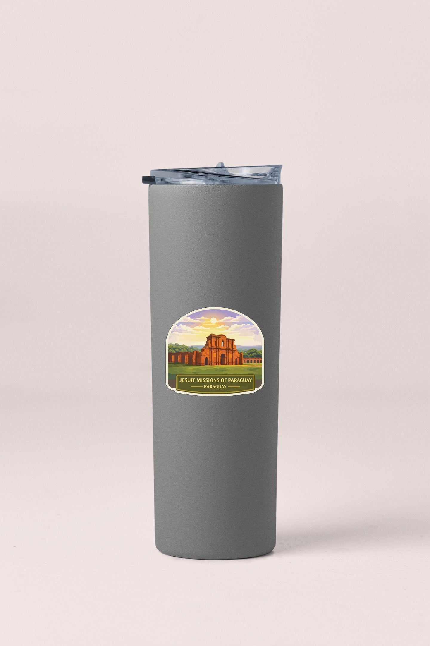 A gray insulated tumbler with a sticker on it, featuring an illustration of a building and the text "JESUS' MISSIONS OF PARACAYA" and "PENRICH".