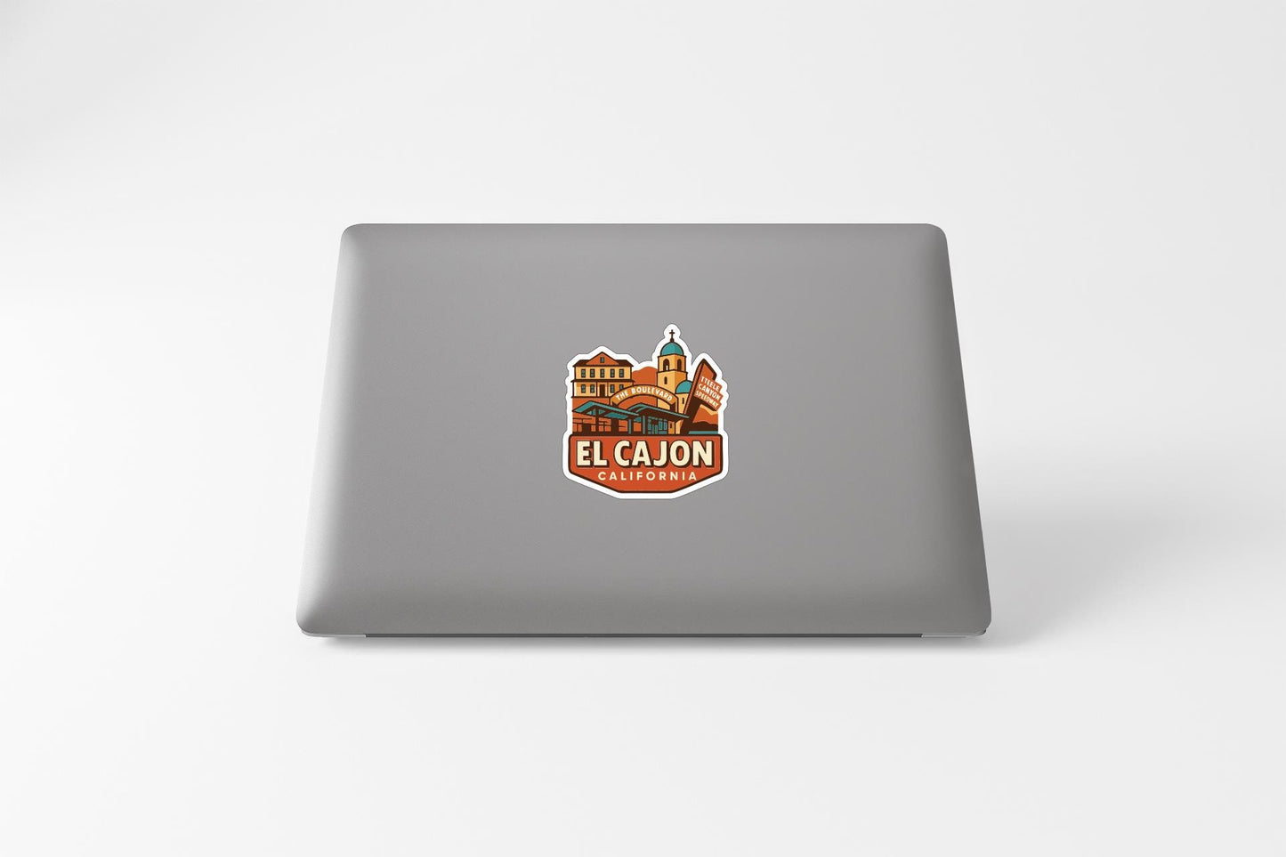 a sticker with a graphic of a building and the text "EL CAJON, CALIFORNIA" on a laptop.