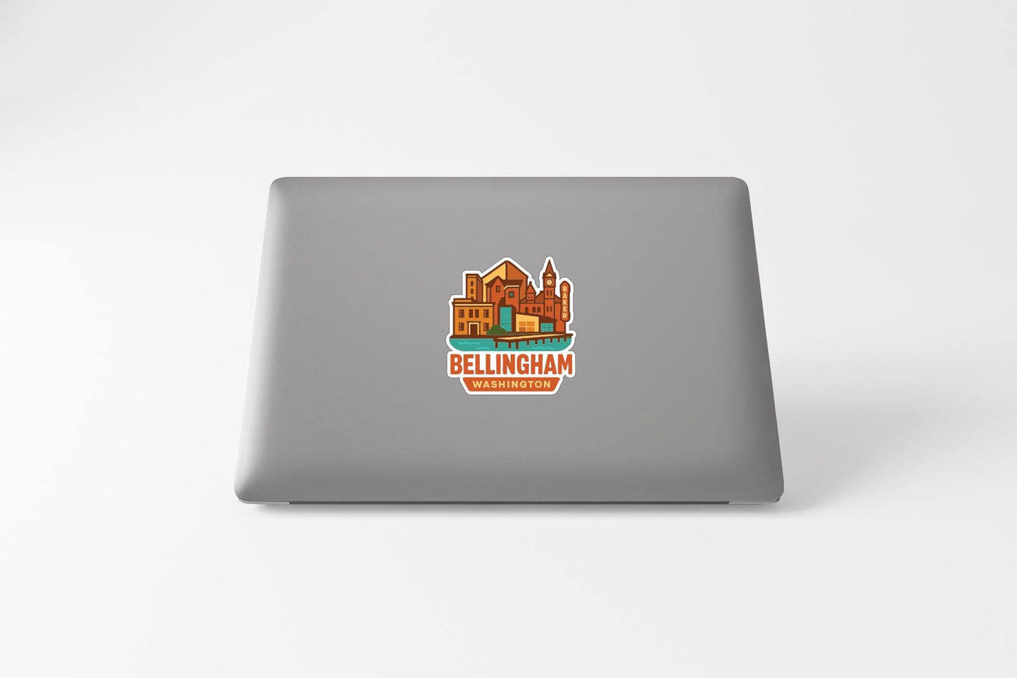 a sticker of a cityscape on the back of a laptop.