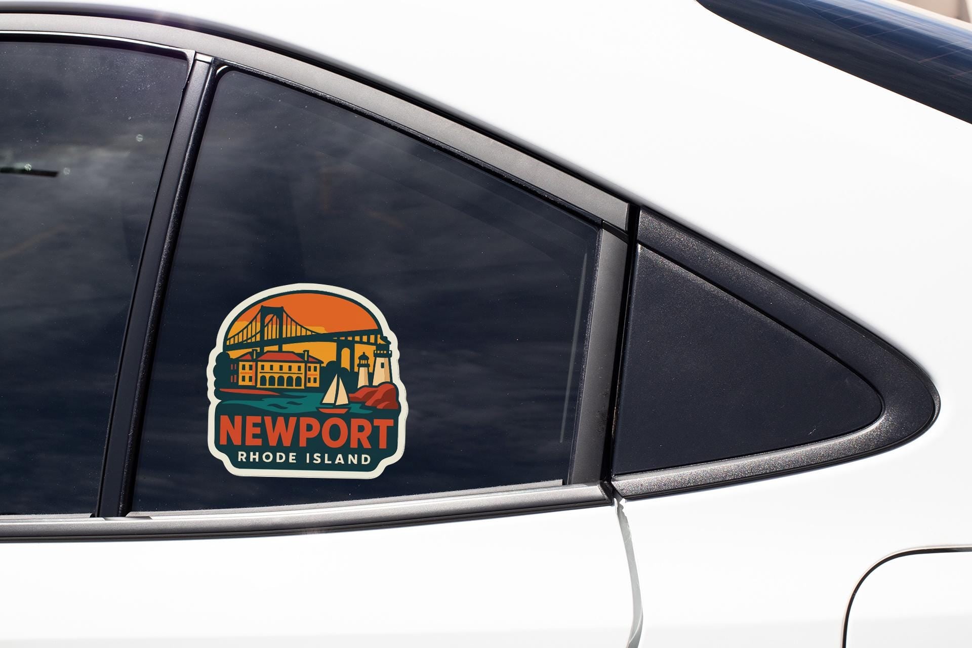 A car window with a sticker depicting a scenic view of Newport, Rhode Island.