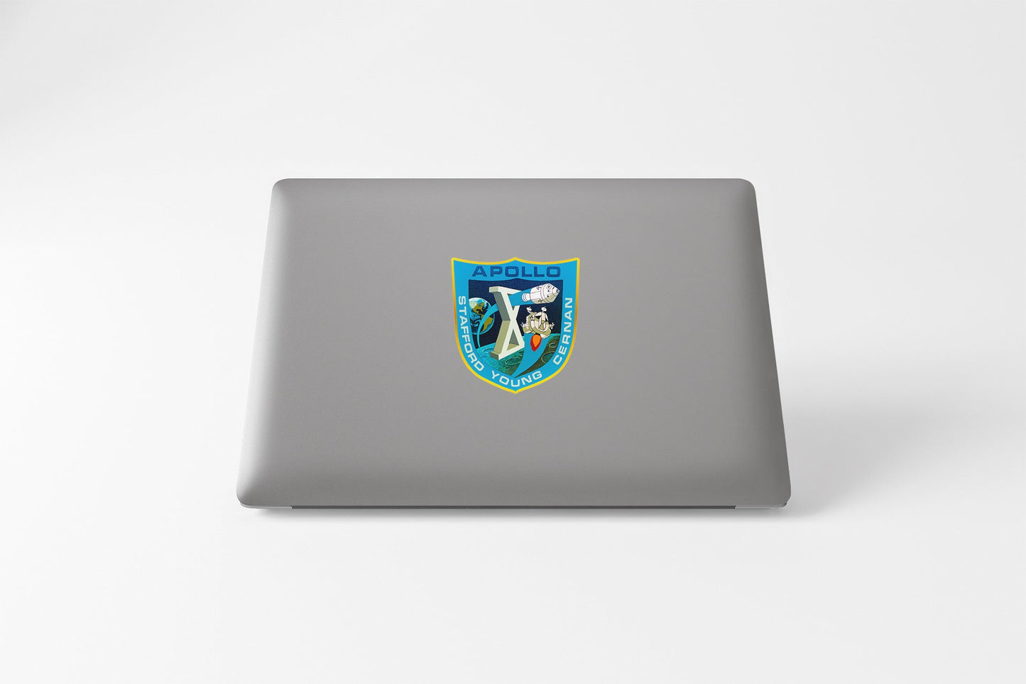 a laptop with a sticker of a shield on it