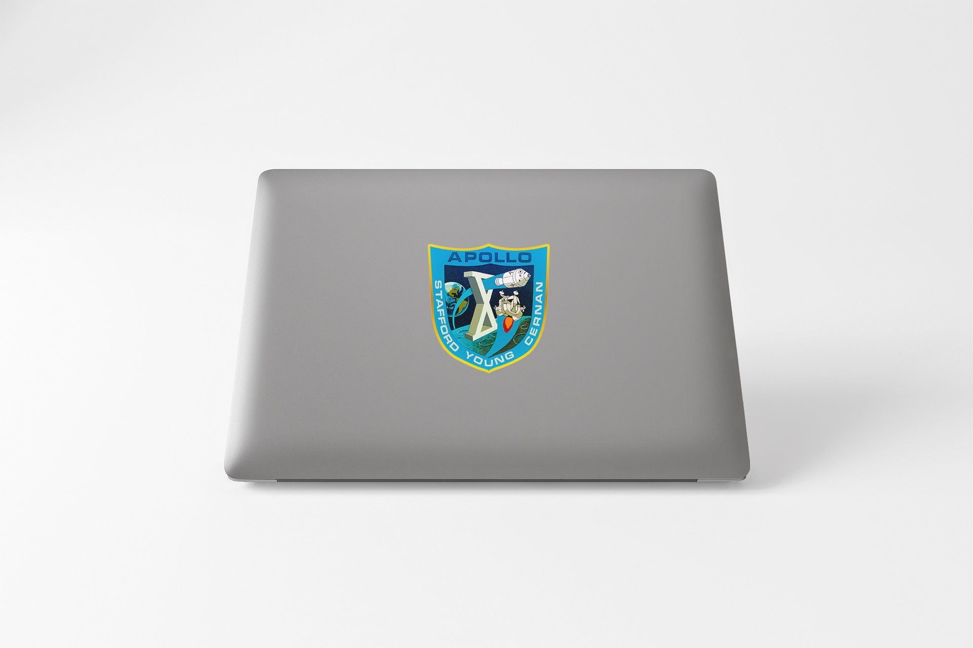 a laptop with a sticker of a shield on it
