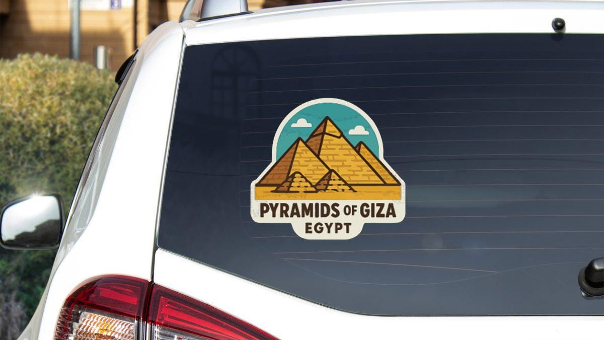 a sticker on the rear window of a car that says "PYRAMIDS OF GIZA EGYPT".
