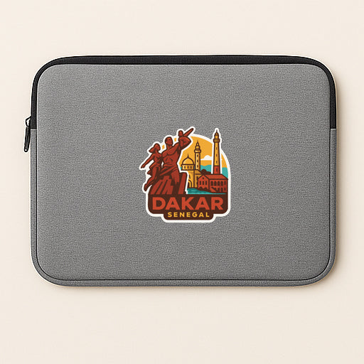 a gray laptop sleeve with a sticker depicting Dakar, Senegal.