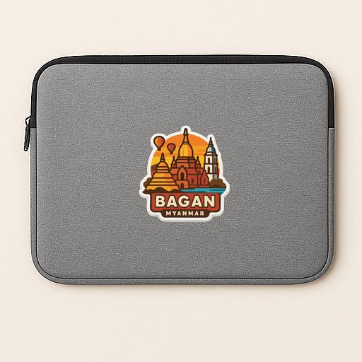 a gray laptop sleeve with a sticker of the city of Bagan, Myanmar.