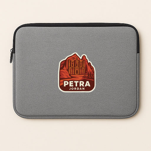 A gray laptop sleeve with a graphic design featuring a mountain landscape and the text "PETRA JORDAN" printed on it.