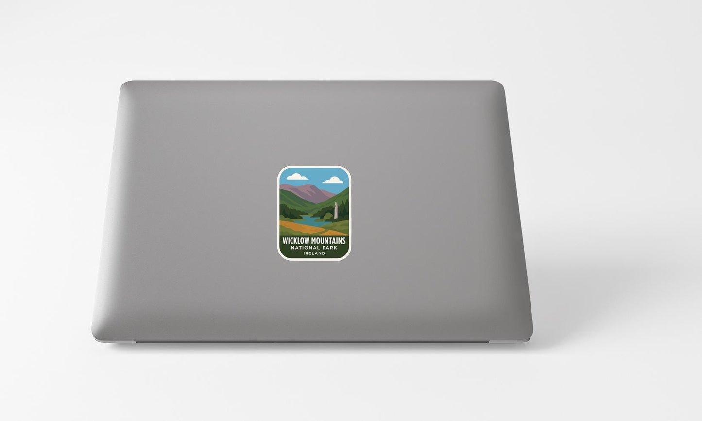 A sticker with a mountain landscape on a laptop.