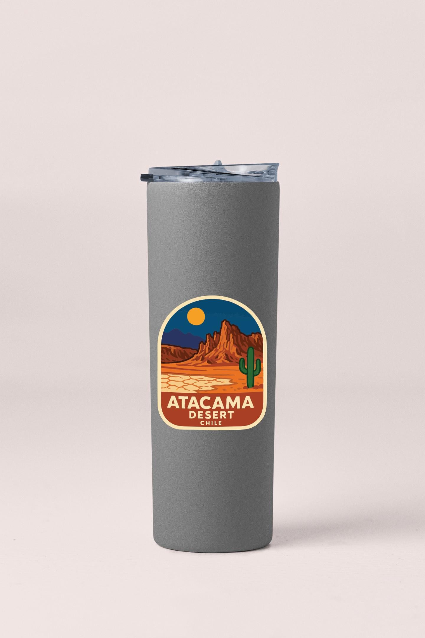 A gray insulated tumbler with a label that features a desert landscape and a cactus.