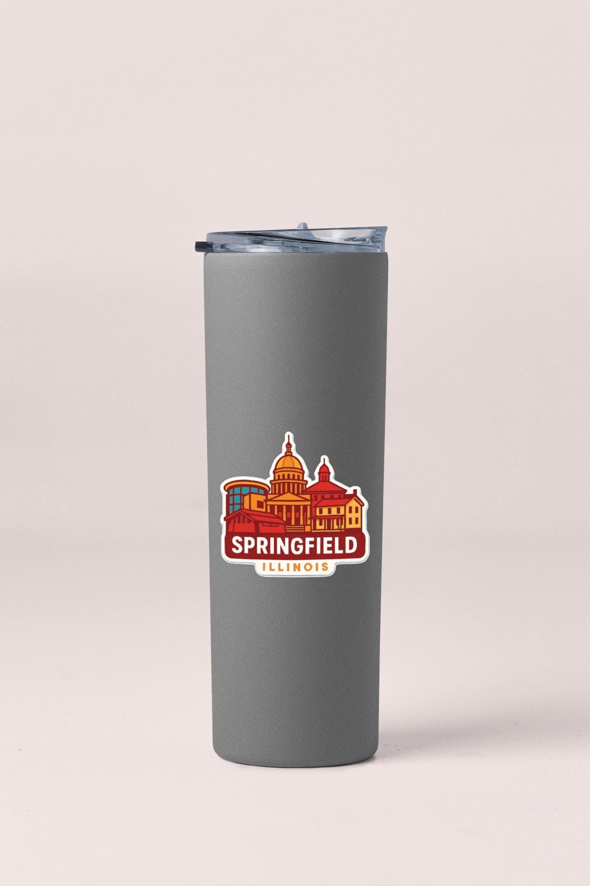 A gray insulated tumbler with a sticker depicting the city of Springfield, Illinois.