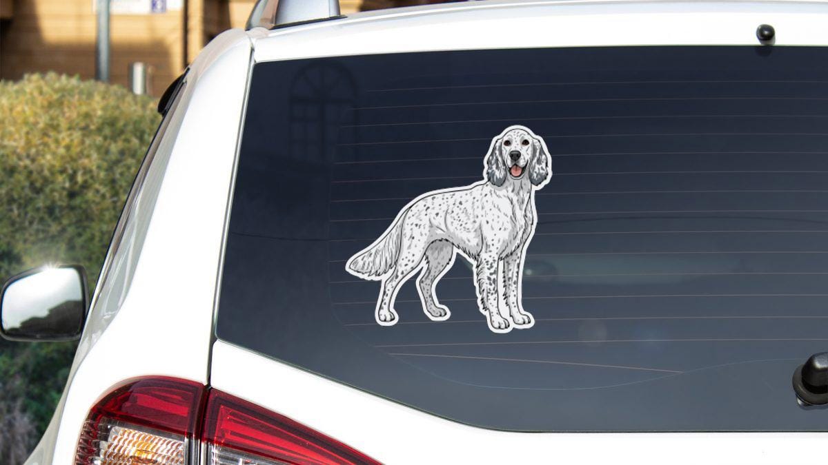 a sticker of a dog on the rear window of a car.