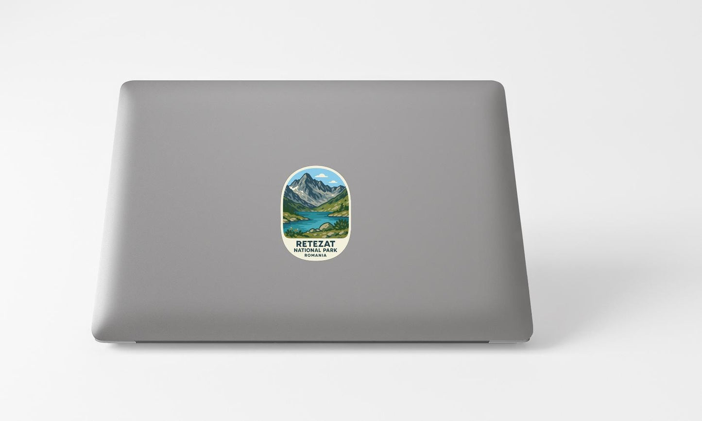 A sticker with a mountain landscape and lake on a laptop.