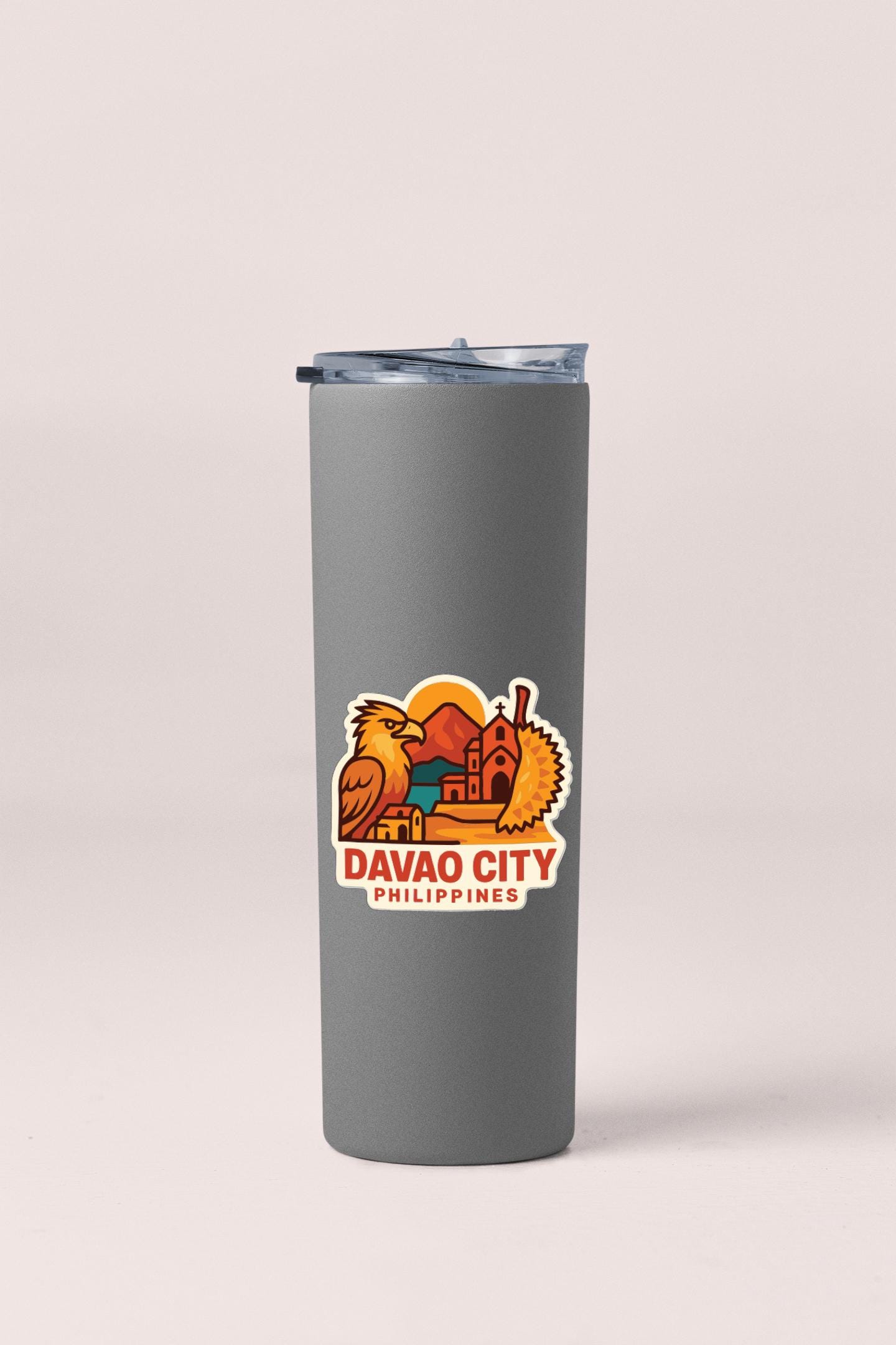 A gray insulated tumbler with a sticker depicting the city of Davao, Philippines.