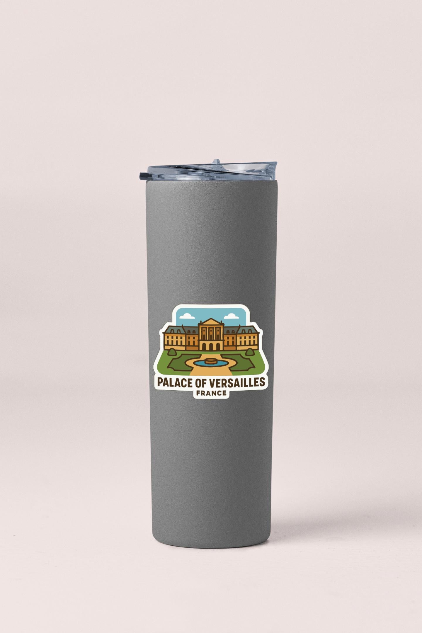 A gray insulated tumbler with a sticker depicting the Palace of Versailles in France.