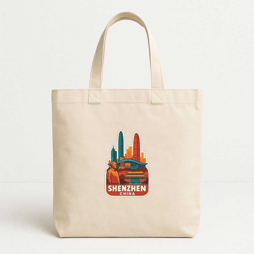 A beige tote bag with a printed design of a city skyline and the text "SHENZHEN CHINA" on it.
